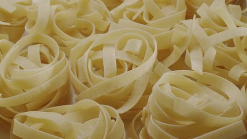 Close Up of Uncooked Ribbon Pasta Bundles