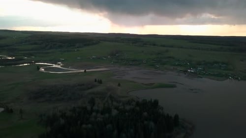 River with curved river near village on cloudy day