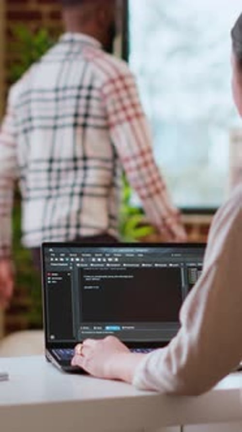 Woman Working on Laptop Computer in Office