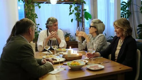Group of Adults Socializing Around a Dinner Table