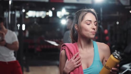 Close Up Face Attractive Woman Look at Camera Smile Drinking Water While Resting in the Gym Bottle