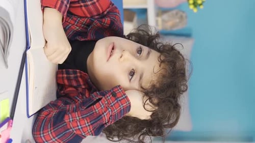 Vertical Video of Tired of intense and tiring classes, the boy is overwhelmed.