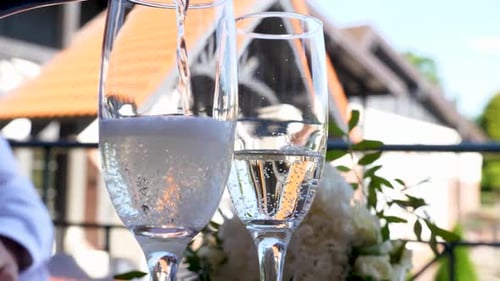 43 1White sparkling champagne is poured into glasses. Alcohol consumption culture.