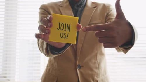 Businessman Holding A Card With Text JOIN US.