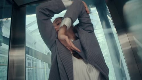 Businesswoman Dancing in Elevator
