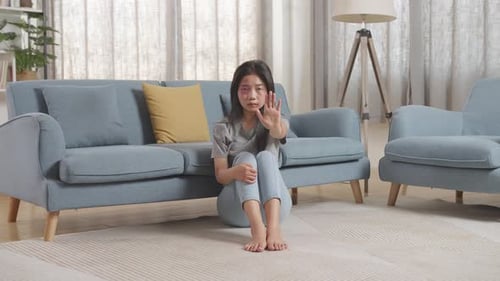 Young Woman Gesturing Stop in Living Room