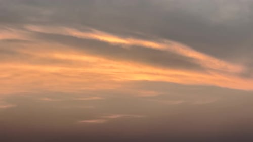 The golden sun dips below the horizon, casting a warm glow over the serene sunset lake.