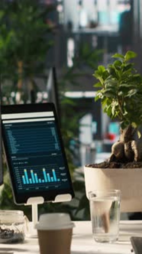 Vertical Video Computer Screen on Office Desk Displaying Financial Charts