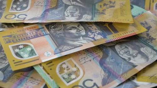 Close up of Australian money falling onto table, currency falling