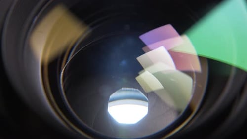 Aperture blades opening and closing slowly with a white background in a de-clicked lens. Macro shot.