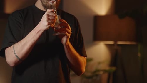 A man smoking Marijuana, half body shot