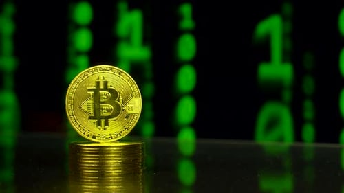 Pile of Bitcoins With Binary Code Blockchain Background