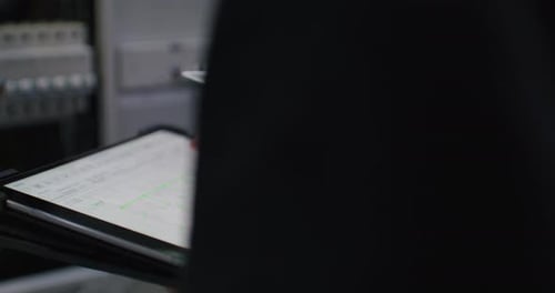 Hand Uses Stylus on Tablet in Office