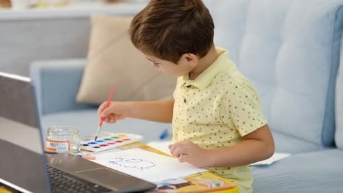 Young Boy Painting an Animal Drawing at Home