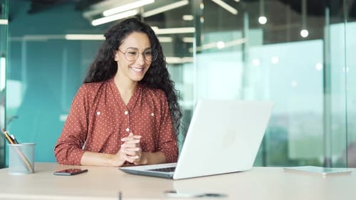 Young Woman on Video Call in Modern Office