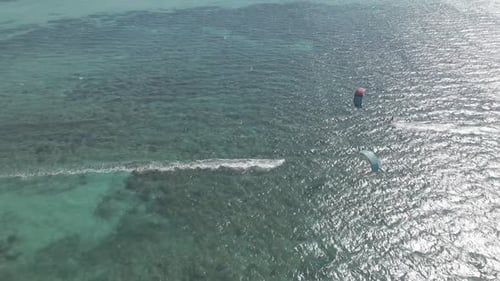 Kitesurfer sailing fast behind there kite In the Pacific Ocean near Exmouth Australia on a bright su