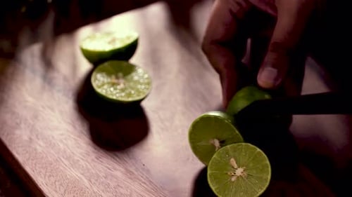 Hand use Knife to Cut Lime in Half, Close Up, Set up