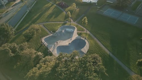Skateboarder Riding a Skateboard in a Skate Park Drone Shot Top View