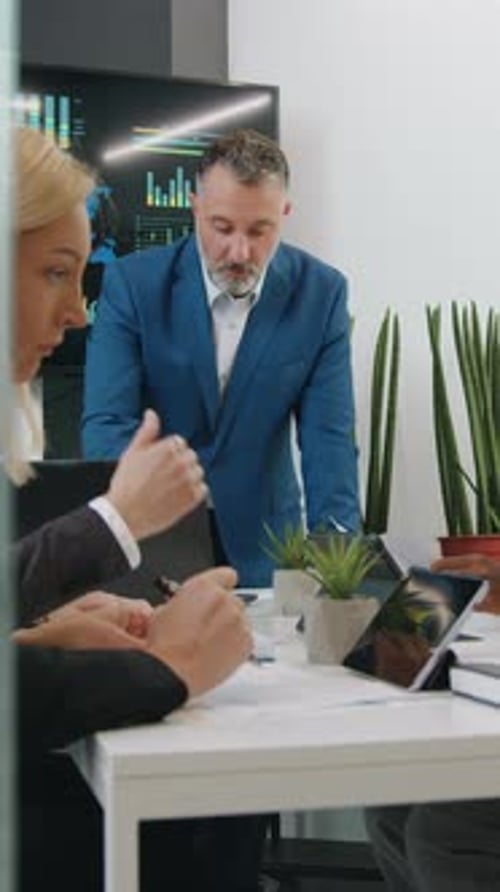 Business Team Meeting at Table in Conference Room