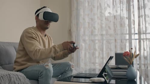 Young Adult Playing VR Game in Living Room