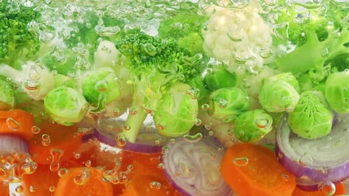 Vegetable mix for making soup in boiling water with air bubbles.