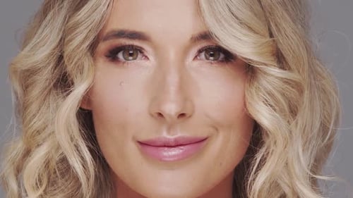 Studio Portrait of Young and Beautiful Blond Woman Over Grey Background Skin Care and Wellness