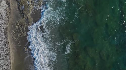 Aerial Video of a Coastal Paradise With Azure Waters and a Textured Sandy Beach Shaped By Ocean