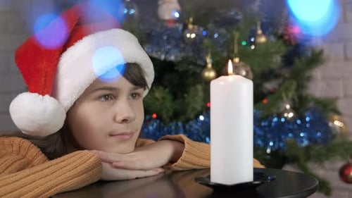 Child Make a Wish By Burning Christmas Candle