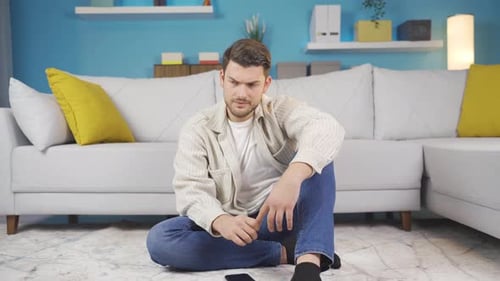 Young Adult Using Phone in Living Room