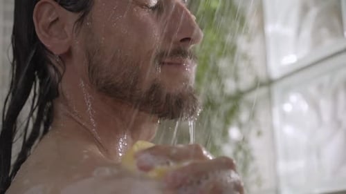 Man Taking a Shower with Sponge