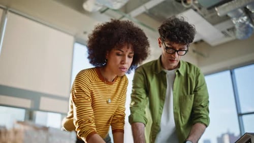 Engineers Reviewing Project Papers at Building Company Office Two Architects