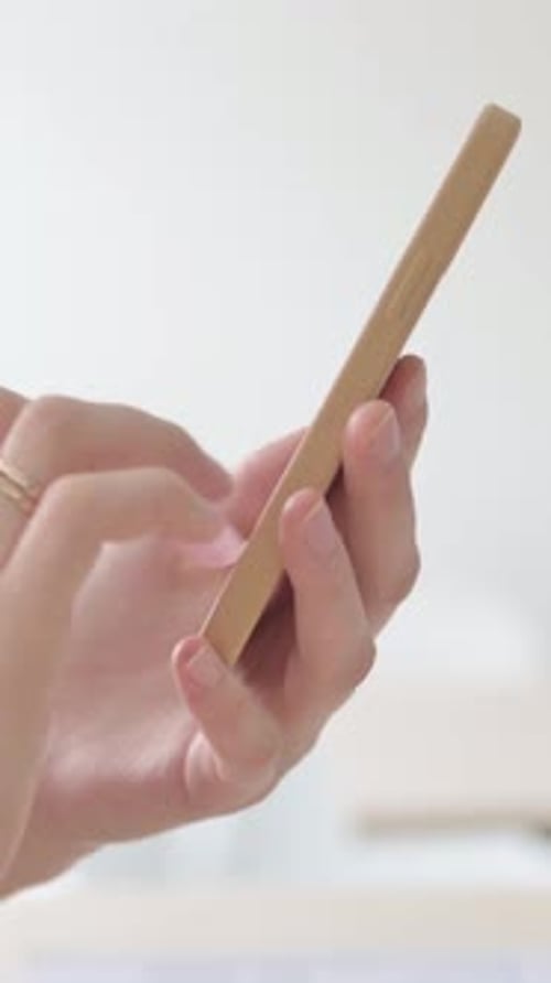 Close up of Female Hand Using Smartphone, Vertical Video