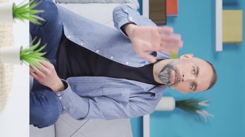 Vertical Video of The man who listens to the news curiously does not like it and does not want it.