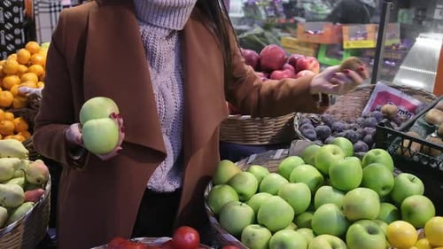 Woman Shopping For Fruit at Indoor Market