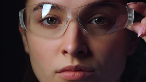 Serious Businesswoman Wearing Virtual Reality Glasses In Office. Closeup Of Focused Young Woman R...
