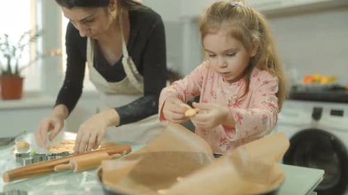 A Warm and Creative Baking Moment Mother and Daughter Making Cookies