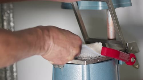 Adult Prepares Dental Molds with Tool