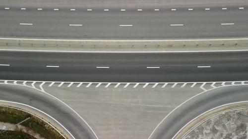 Top Down Aerial View of New Highway High Speed Road Intersections with Few Vehicles Moving in the