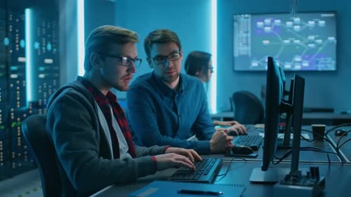Team of engineers work in server room
