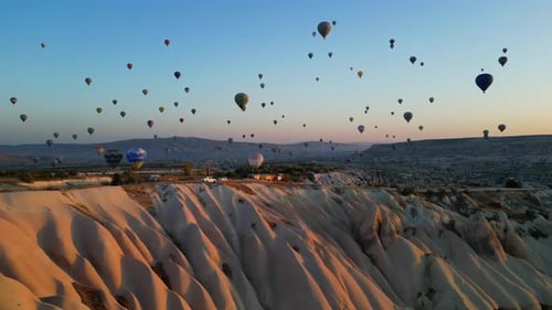 Hot Air Balloons Over Dreamy Canyon Landscape at Sunrise