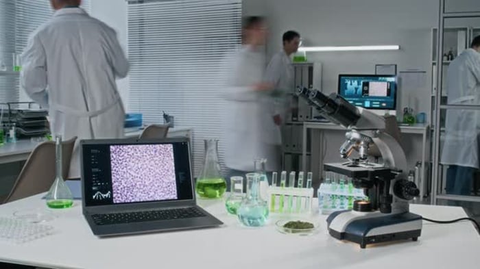 Scientists working in a lab with microscopes and beakers, Time Lapse ...
