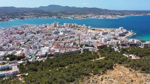 Aerial drone footage of the town of Sant Antoni de Portmany on the west coast of Ibiza in Spain