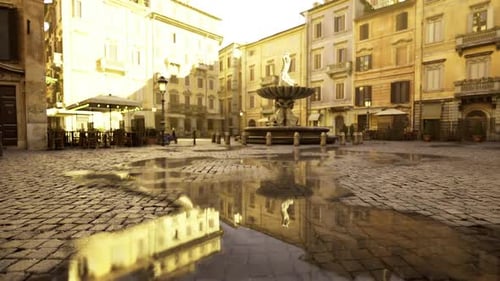 Rainsoaked Cobblestones Mirror Bright Shop Fronts and Street Lamps