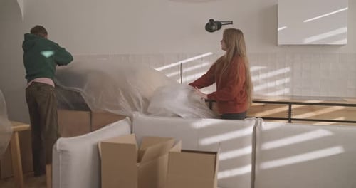 Young Couple Unpacking in Bright Apartment