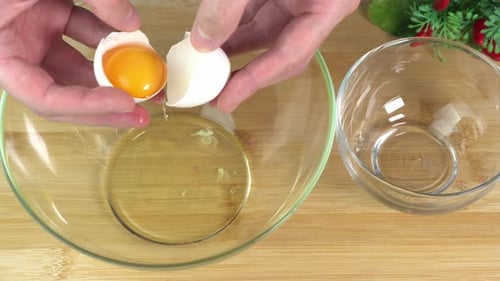 Hands Cracking Egg into Bowl for Cooking