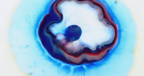 Abstract Footage of Colorful Ink Mixing and Expanding