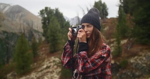 Photographer Taking Pictures in Mountain Forest with Vintage Camera