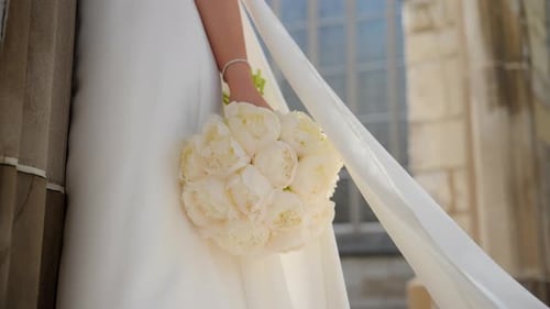 Elegant Bride Holds Wedding Bouquet Close Up