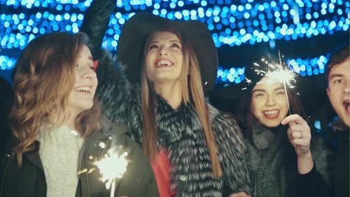 Joyful Friends Celebrate with Sparklers at Night