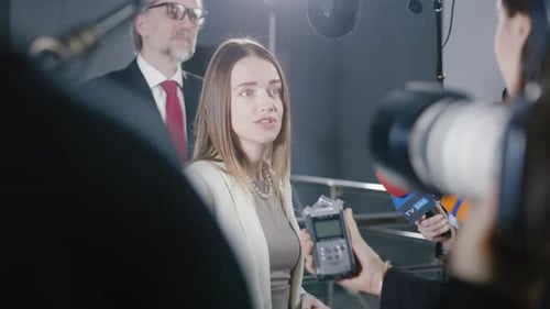 Woman Giving Interview to Press at Corporate Event